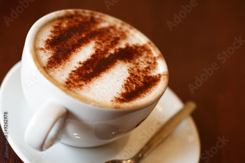 wonderful cappuccino coffee in white cup, shallow DOF photo