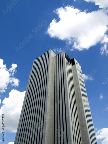 Skyscraper on a background of a blue sky and clouds.