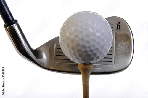Golf club with ball on a tee isolated
