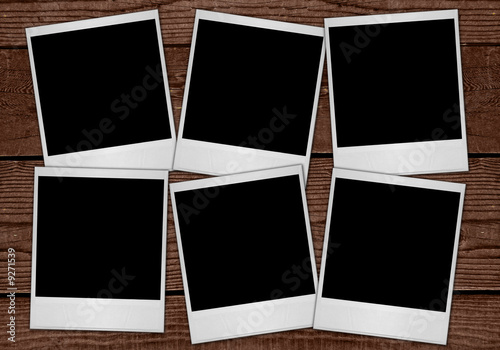 Multiple Polaroid Film Blanks Sitting on Wood Background