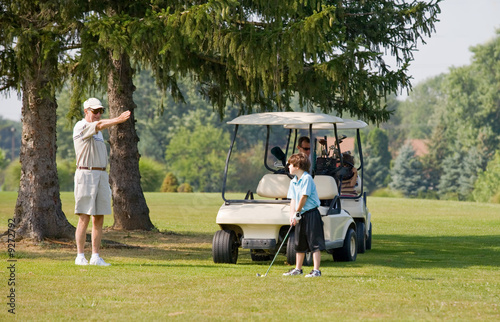 Grandpa Instructing Grandson in Golfing