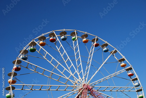 Ferris wheel on background blue sky