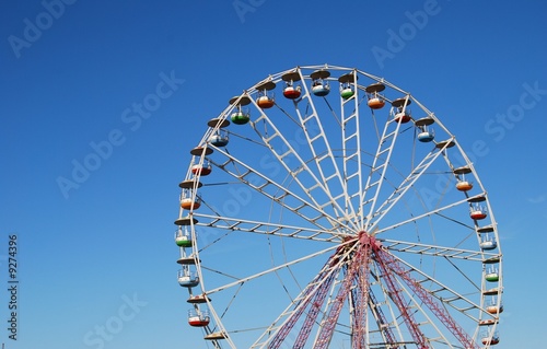 Ferris wheel on background blue sky