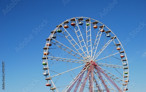 Ferris wheel on background blue sky
