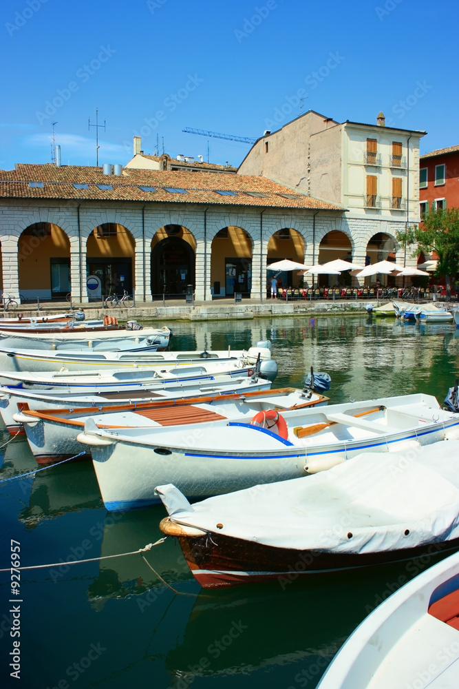 Boats in a row in a small harbor of Desenzano near Garda