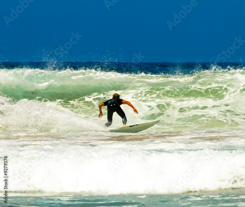 Surfer on an amazing wave on a perfect sunny day