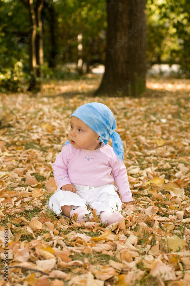Little baby sitting comfort in park.