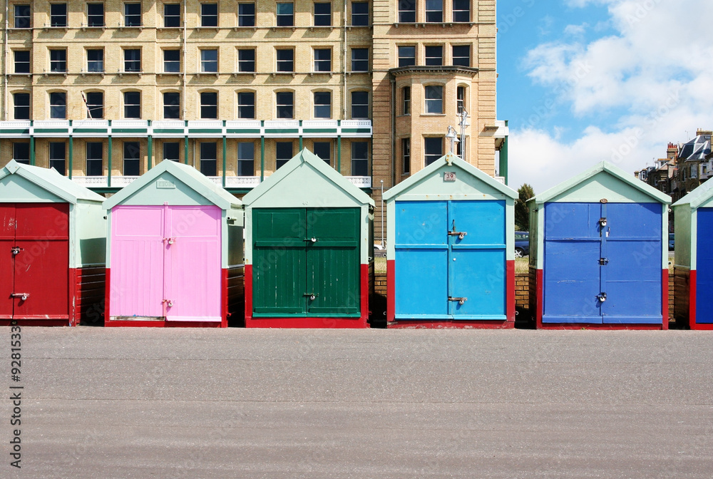 A photography of colorful houses at the beach in Brighton A photography of colorful houses at the beach in Brighton