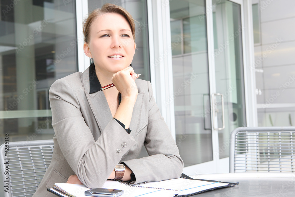 A pretty young business woman at company office building A pretty young business woman at company office building