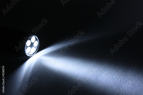 Beam from flashlight closeup on paper