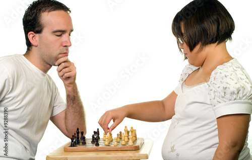 A young man and a girl playing a game of chess,