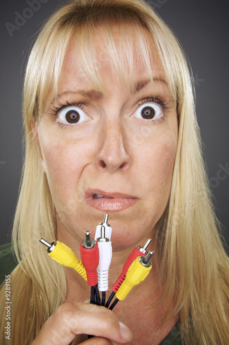 Confused Woman Holds Electr...