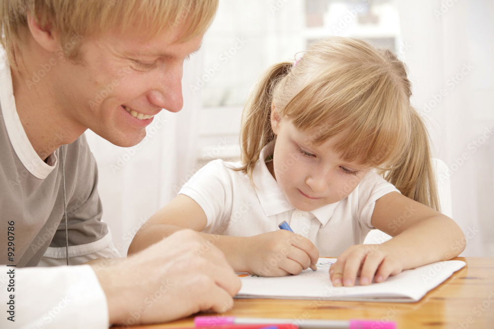 Portrait of little girl painting something and her father Portrait of little girl painting something and her father