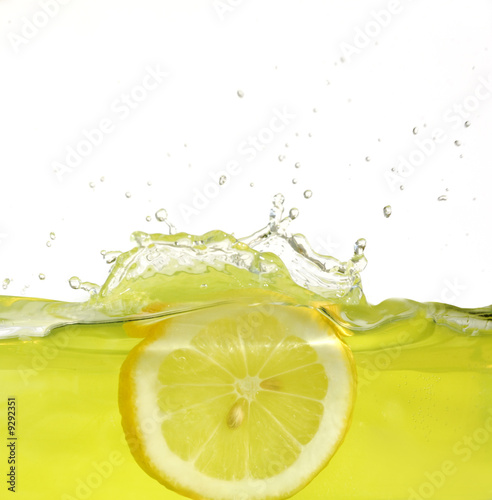 Image of lemon slice falling into juice #9292351