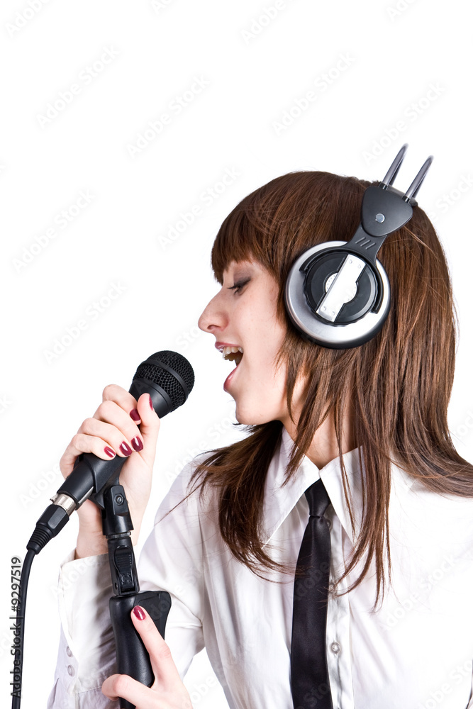 Obraz premium Woman in headphones Singing in Microphone