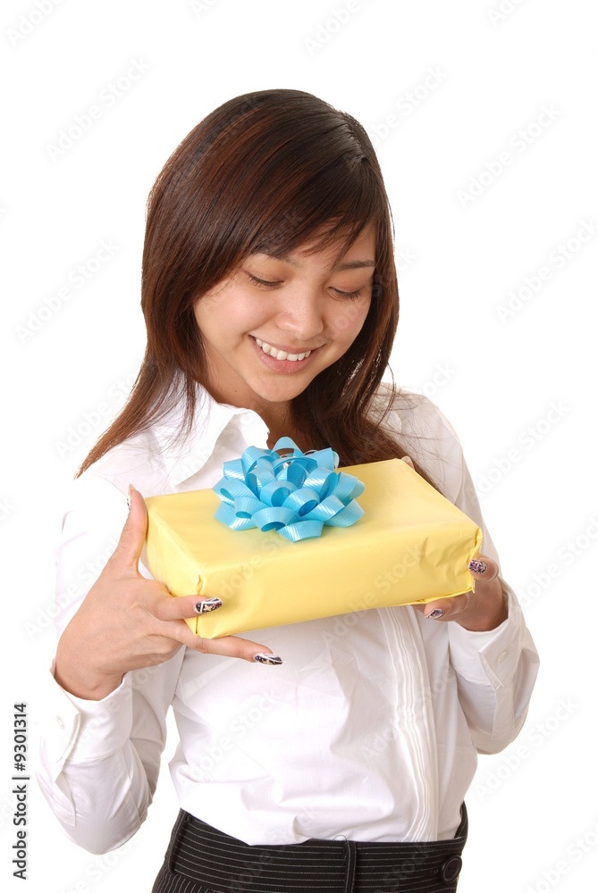 Young Asian girl holding a wrapped package Young Asian girl holding a wrapped package