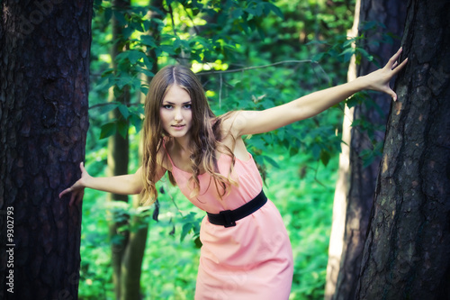 Young woman in mysterious forest. Soft colors.