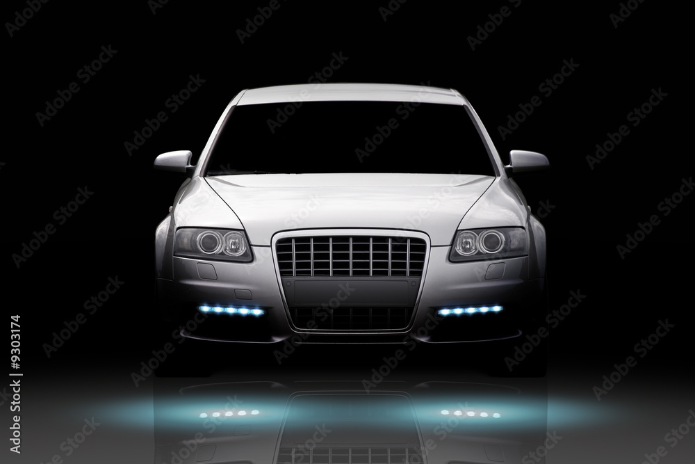 Naklejka premium Front view of a luxury sport sedan isolated on black