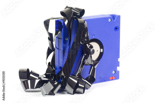 Damaged computer backup tape isolated on white background.