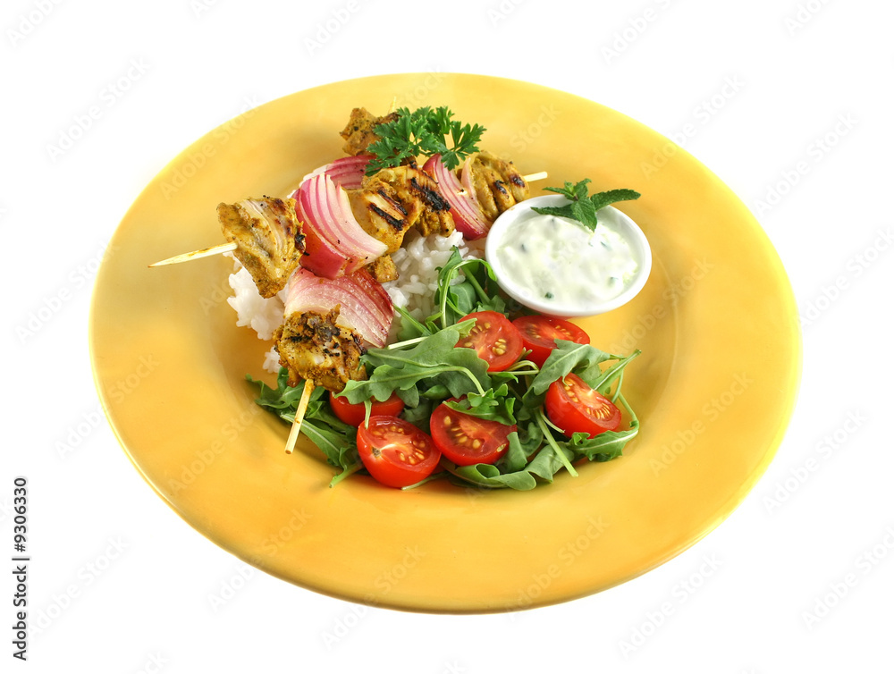 Chicken tandoori skewers with red onion and a rocket salad. Chicken tandoori skewers with red onion and a rocket salad.