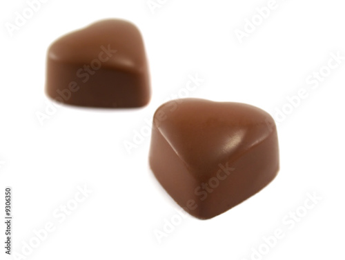 Two delicious and symbolic heart shaped chocolates.