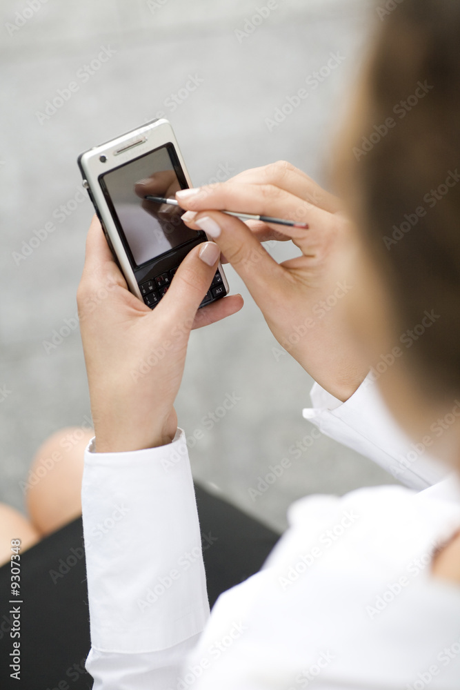 Woman using palmtop, close-up