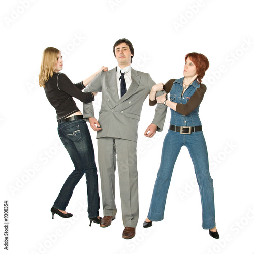 Two women pulling a man in opposite sides