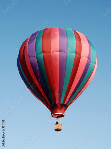 Colorful hot air balloon floating in blue sky