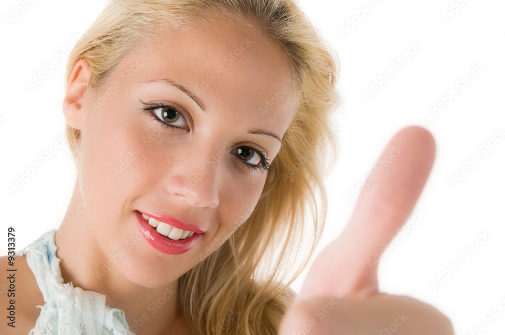 Closeup of a smiling young woman showing thumb's up sign Closeup of a smiling young woman showing thumb's up sign