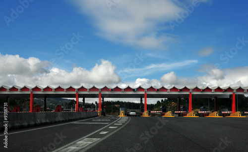 landscape view of a highway toll with cars passin trhough