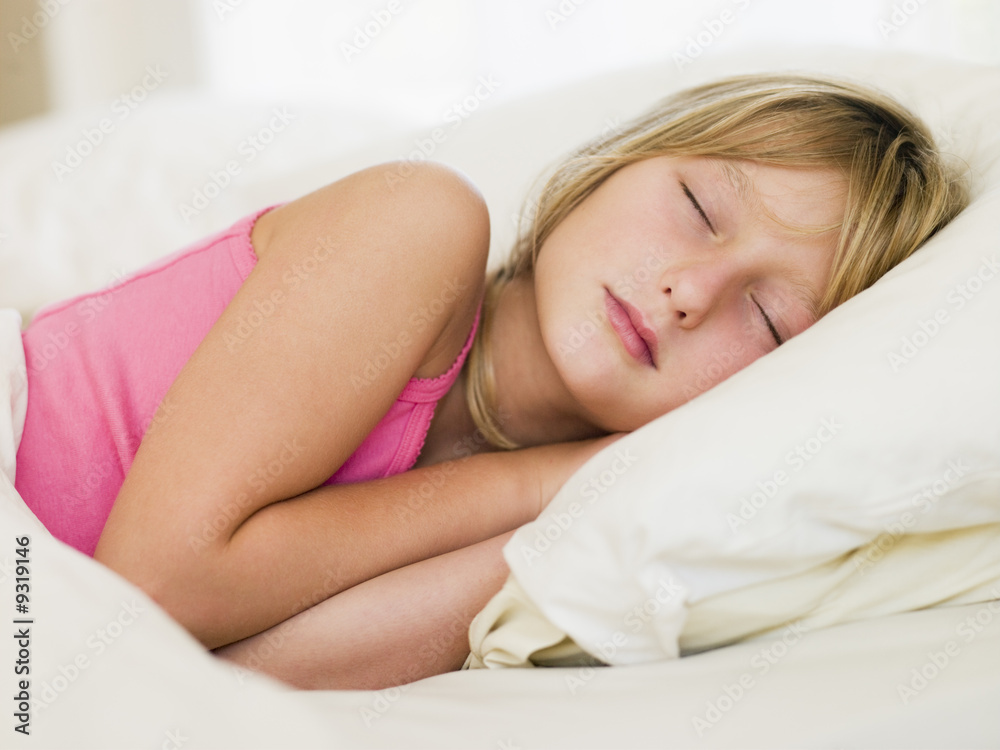Young Girl Lying In Her Bed Stock Photo | Adobe Stock