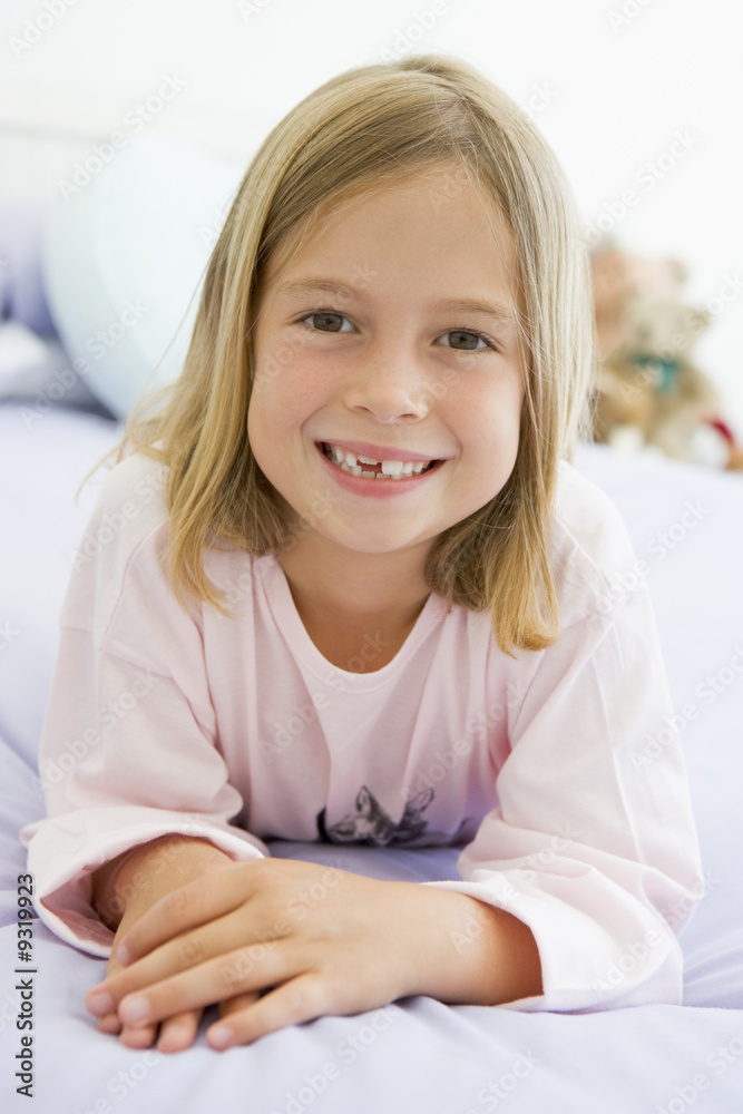 Young Girl Lying On Her Bed In Her Pajamas Young Girl Lying On Her Bed In Her Pajamas