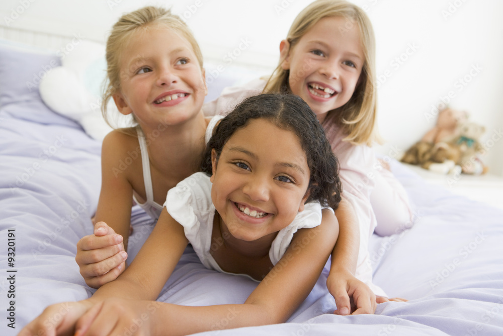 Three Young Girls Lying On Top Of Each Other In Their Pajamas Three Young Girls Lying On Top Of Each Other In Their Pajamas