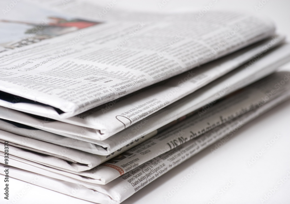 Newspapers on light background with shallow depth of focus Newspapers on light background with shallow depth of focus