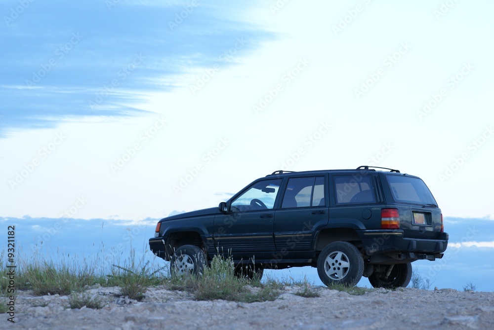 Four wheel drive vehicle sitting in a remote desert location. Four wheel drive vehicle sitting in a remote desert location.
