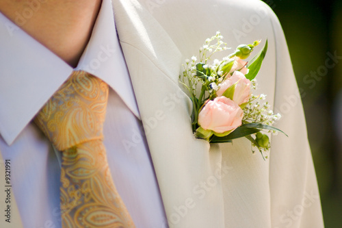 buttonhole with tea-rose detail of groom's dress photo