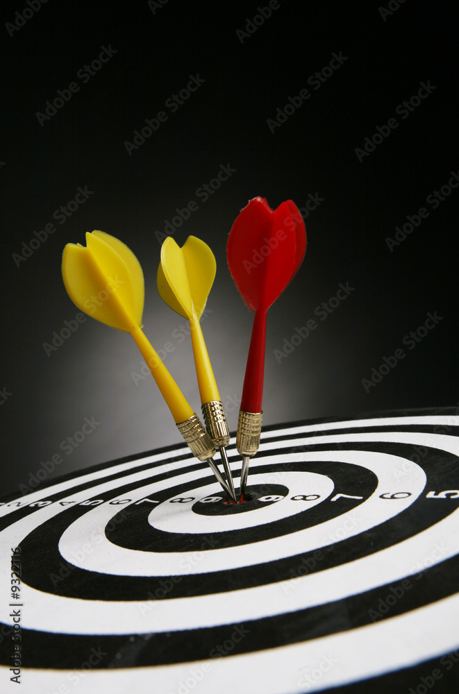 Three darts on bull's eye of a dart board