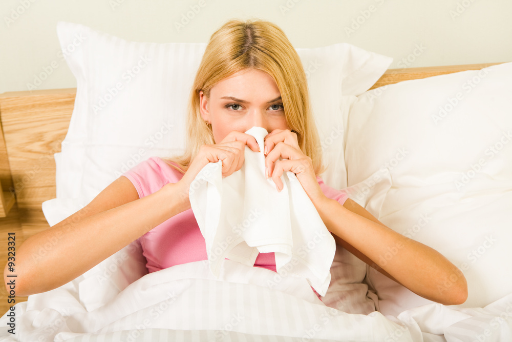 Photo of sick woman sitting in bed