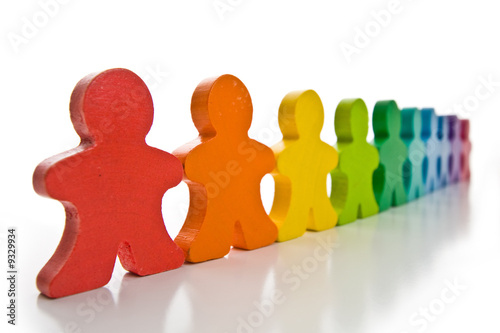 Brightly colored wooden people isolated on a white background.