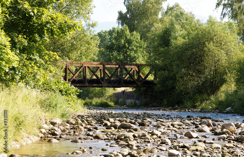 Landscape with Stream and old rusted ralway bridge. photo