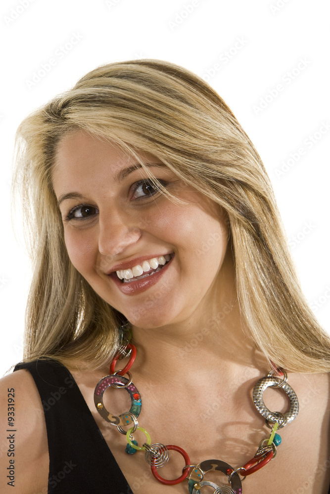A blonde wearing a fashion necklace and a big smile