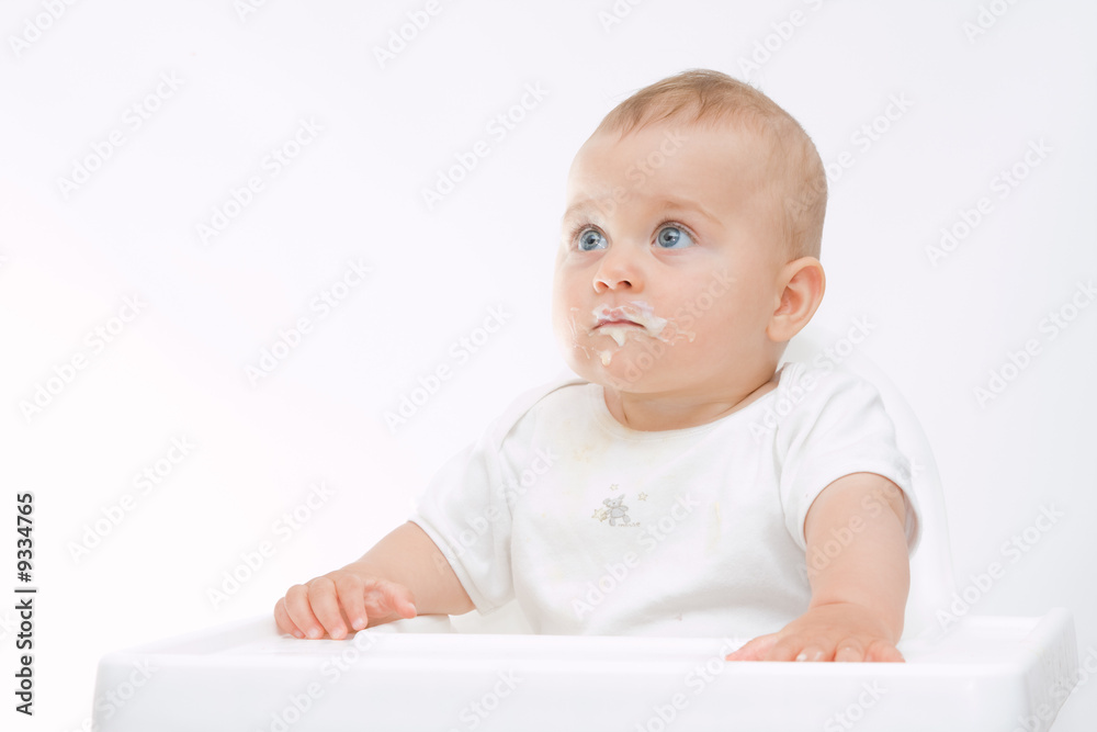 baby boy with dirty face sitting in highchair baby boy with dirty face sitting in highchair