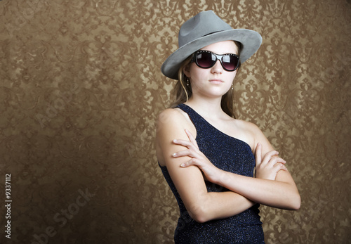 Young girl wearing a fedora and dark sunglasses © Scott Griessel