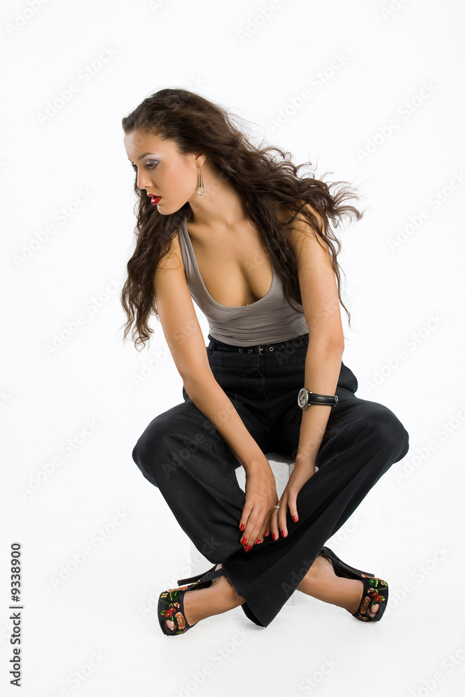 Young brunette woman in black trousers and grey shirt Young brunette woman in black trousers and grey shirt