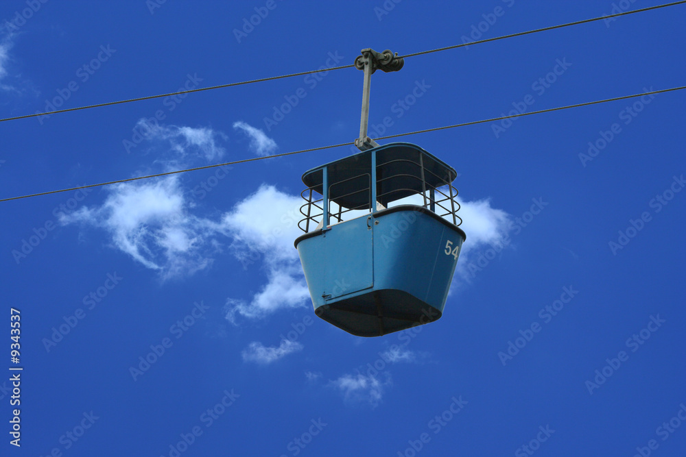A Gondola lift car against blue sky A Gondola lift car against blue sky