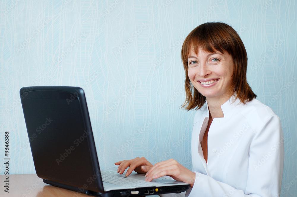 Young woman in office working with laptop Young woman in office working with laptop