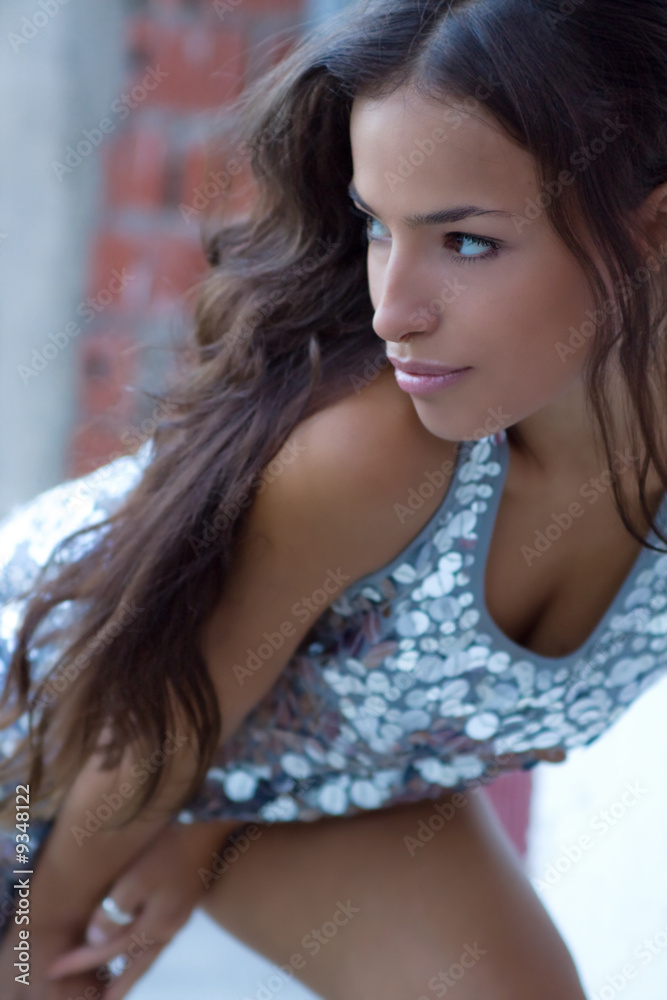 young woman posing in shiny dress outside in dusk young woman posing in shiny dress outside in dusk