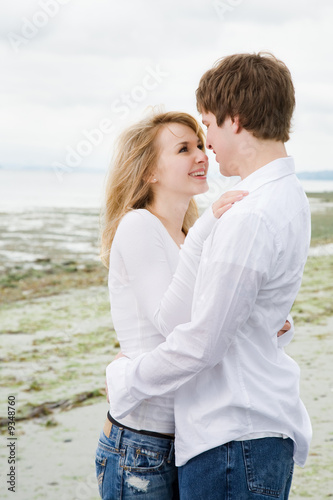 A shot of a caucasian couple in love on the beach