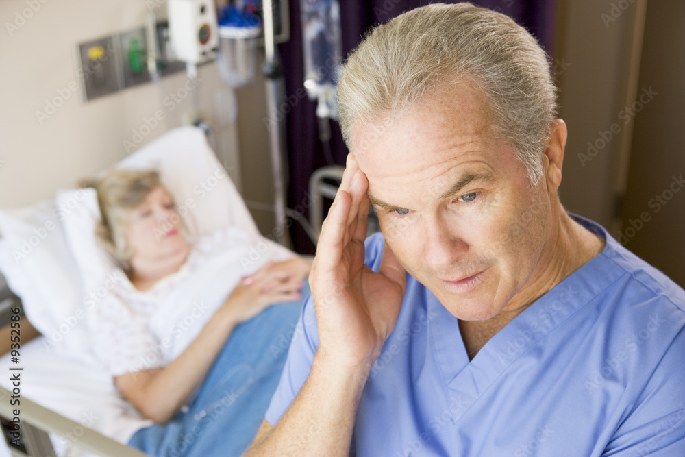 Fototapeta premium Doctor Standing In Patients Room,Looking Frustrated