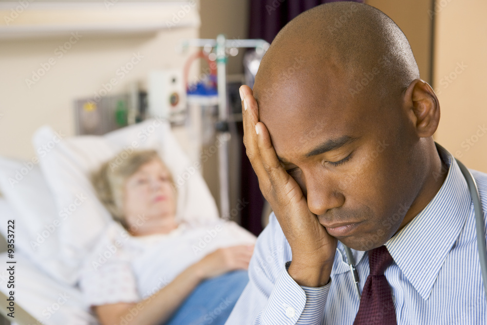 Doctor Looking Tired And Frustrated In Hospital Room Doctor Looking Tired And Frustrated In Hospital Room